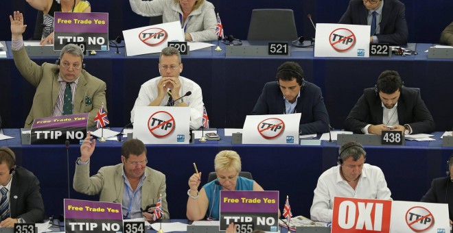 Members of the European Parliament with posters on the desks which read 'no TTIP' take part in a voting session at the European Parliament in Strasbourg, France, July 7, 2015. The European parliament will vote on Wednesday on the E.U.-U.S. Transatlantic T