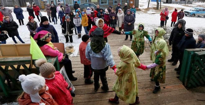 Un grupo de personas celebran una fiesta local en el antiguo campo de trabajo de Tugach, donde viven en paz hijos y nietos de prisioneros junto con los de los antiguos carceleros. (ILYA NAYMUSHIN | REUTERS)