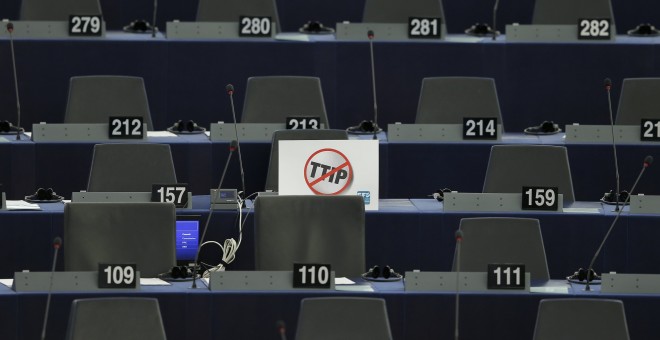 A poster which reads 'no TTIP' is seen on the desk of a member of the European Parliament during a debate in Strasbourg, France, July 7, 2015. The European parliament will vote on Wednesday on the E.U.-U.S. Transatlantic Trade and Investment Partnership (