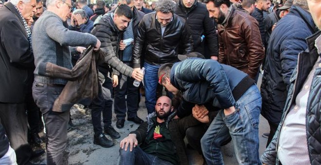 An injured protester is helped by others as supporters of Albanian opposition shout anti Government slogans during a protest in front of the government building in Tirana, Albania, 16 February 2019. Reports state that they are demanding the resignation of