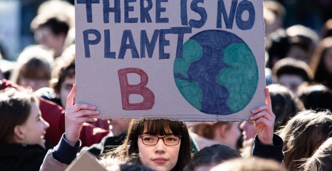 Manifestantes muestran pancartas durante una marcha contra el calentamiento global, este viernes, en Berlín, Alemania./EFE