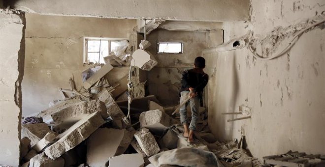 Un niño yemení inspecciona un edificio destruido tras sufrir un ataque aéreo por parte de las fuerzas saudíes. EFE