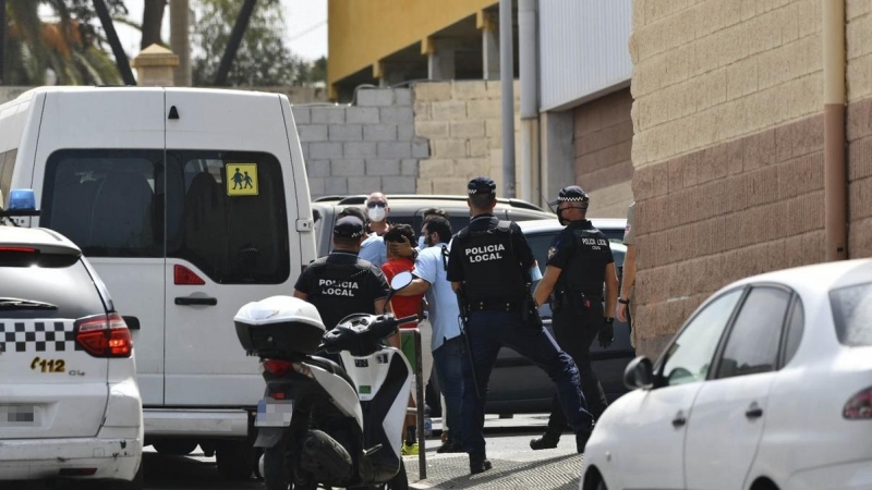Varios agentes acompañan a menores no acompañados hacia una furgoneta en Ceuta