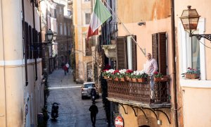 A man looking out onto the balcony of his house in the Trastevere district deserted due to the coronavirus outbreak in Rome, Italy 16 March 2020. Italy is under lockdown in an attempt to prevent the spread of the pandemic Coronavirus. Several European cou
