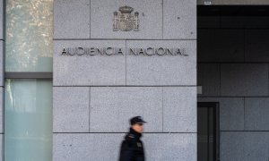 Un agente de Policía Nacional camina frente a la Audiencia Nacional, a 8 de enero de 2024, en Madrid.