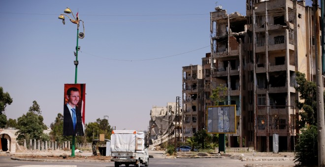 Un cartel del presidente sirio Bashar al-Assad en el distrito de Waer en la ciudad siria central de Homs, Siria / Omar Sanadiki - REUTERS