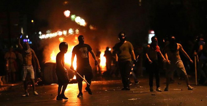 Manifestantes se enfrentan con la policía antidisturbios durante la manifestación.- EFE