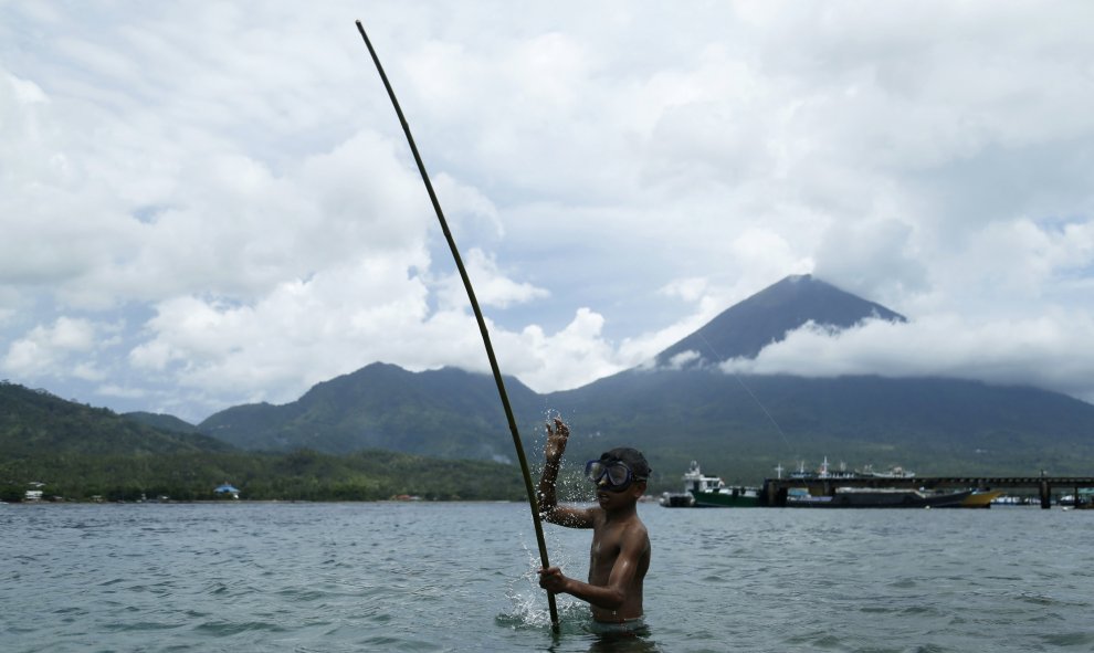 Un niño sostiene una caña de pescar en la playa de la isla de Maitara en Tidore, Indonesia. REUTERS/Beawiharta