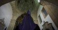 A hooded penitent of the "Numeraria del Rosario" brotherhood waits for the start of the Santo Entierro procession at the San Domingos de Bonaval church, during Holy Week in Santiago de Compostela, northwestern Spain, on March 25, 2016. Christian believers