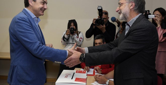 El expresidente del Gobierno José Luis Rodríguez Zapatero saluda al presidente de la mesa, tras depositar su voto en la sede provincial del PSOE en León, dentro del proceso de primarias. EFE/J. Casares