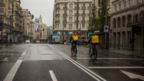 tRABAJADORES DE gLOVO cruza la Gran Vía de Madrid durante el estado de alarma decretado por el coronovirus, el 31 de marzo de 2020.-JAIRO VARGAS