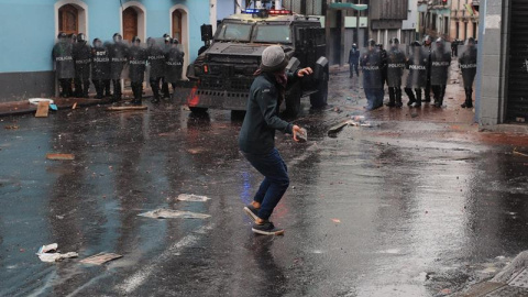 Manifestantes se enfrentan con la Policía durante una jornada de protesta contra las medidas económicas del Gobierno del presidente Lenín Moreno este jueves en Quito (Ecuador). - EFE