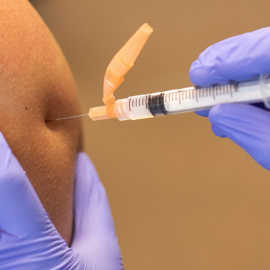 FILE PHOTO: A CalFire firefighter is administered his first dose of the Moderna vaccine in his arm by a CalFire Emergency Medical Technician during the outbreak of the coronavirus disease (COVID-19) in El Cajon, California, U.S., January 15, 2021. REUTERS