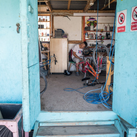 Un niño que asiste al Makerspace en Lesbos mientras intenta arreglar un scooter eléctrico. Lesbos, Grecia