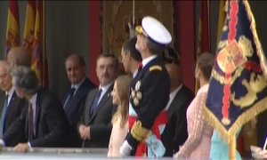 Un paracaidista se queda enganchado a una farola en el desfile del Día de la Hispanidad