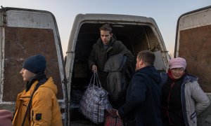 25/03/2022-Personas que huyen de Mariupol, asediada por militares rusos, salen de un monovolumen tras llegar al punto de evacuación en Zaporizhzhia, Ucrania, el 25 de marzo