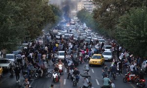 La gente confronta con la policía durante una protesta tras la muerte de Mahsa Amini, en Teherán, Irán.