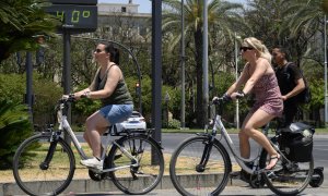 Varias turistas pasean junto a un termómetro de una calle del centro de Sevilla que marca 40 grados, a 31 de mayo de 2024.